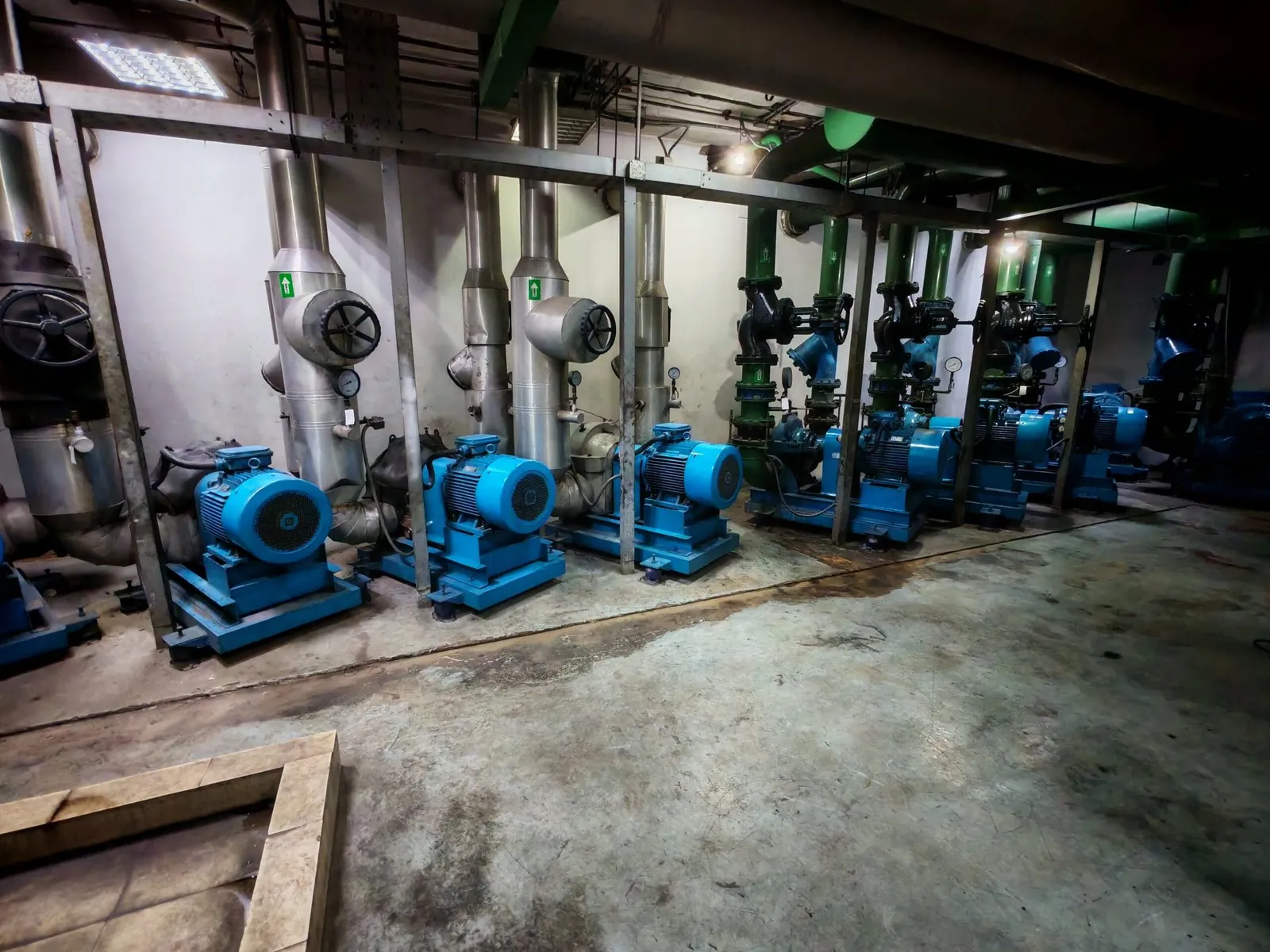 Row of blue pumps in a plant room during a site survey