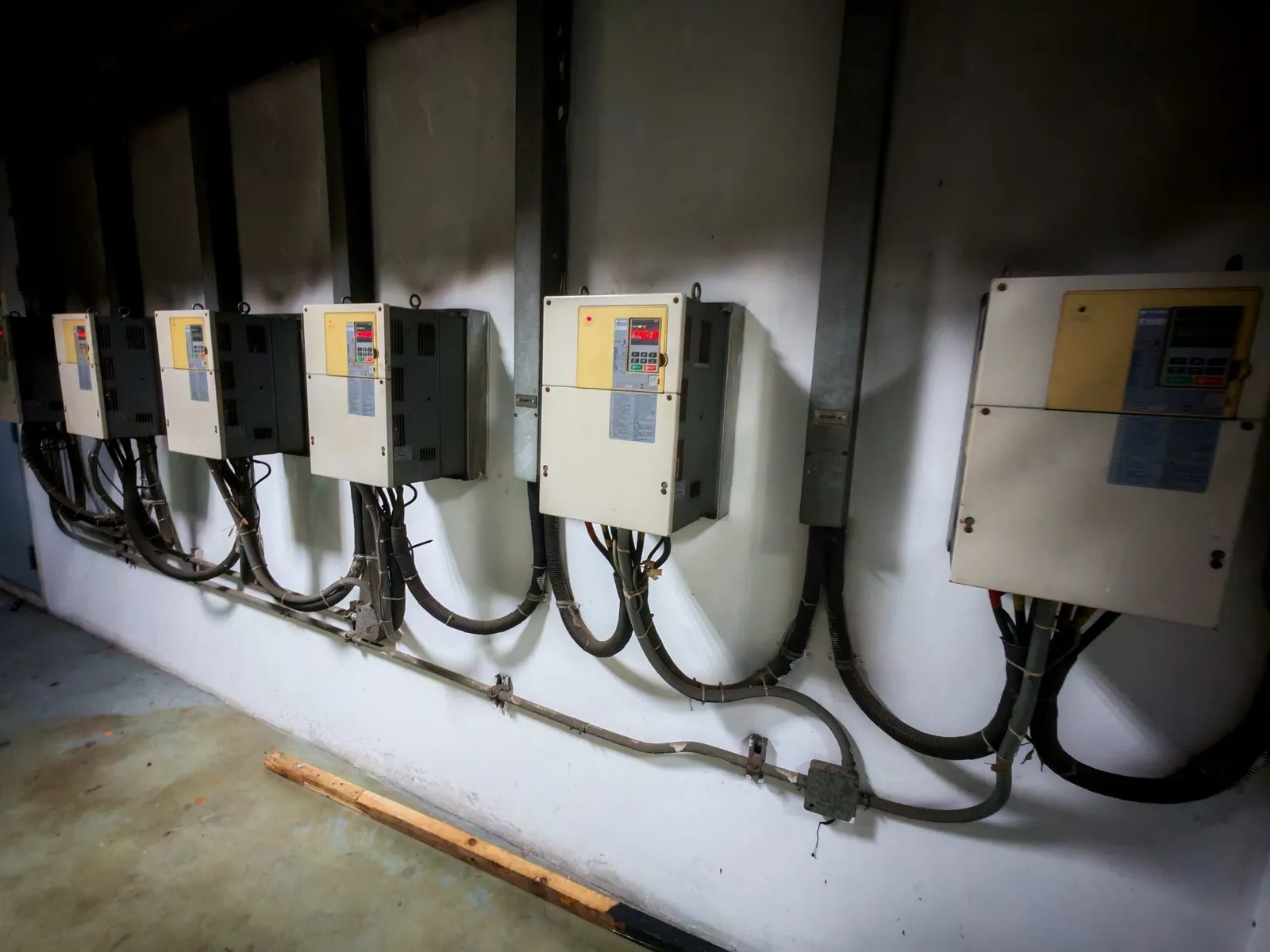 Row of variable frequency drives mounted on a wall