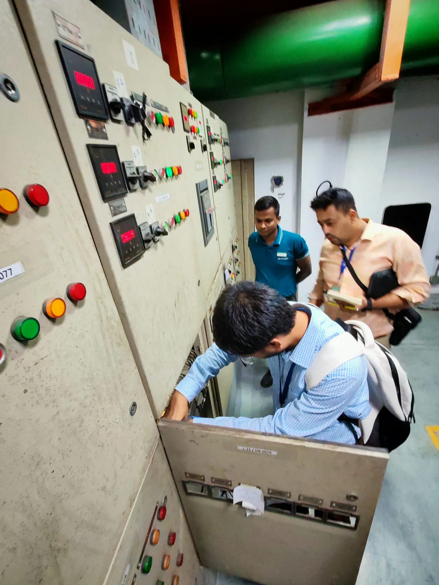 Engineer inspecting a switchgear panel during an electrical audit