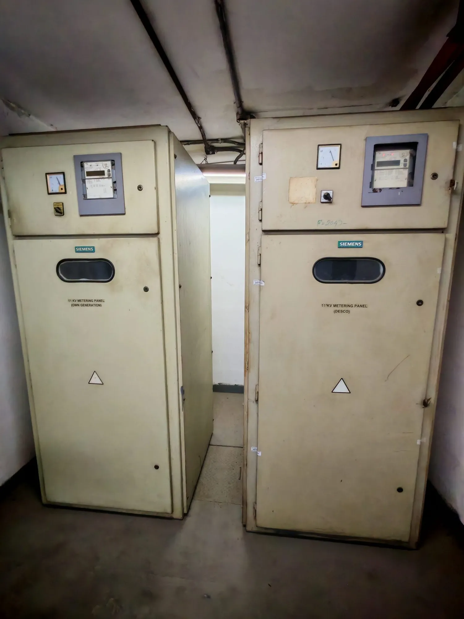 Two medium-voltage switchgear cabinets in a substation room