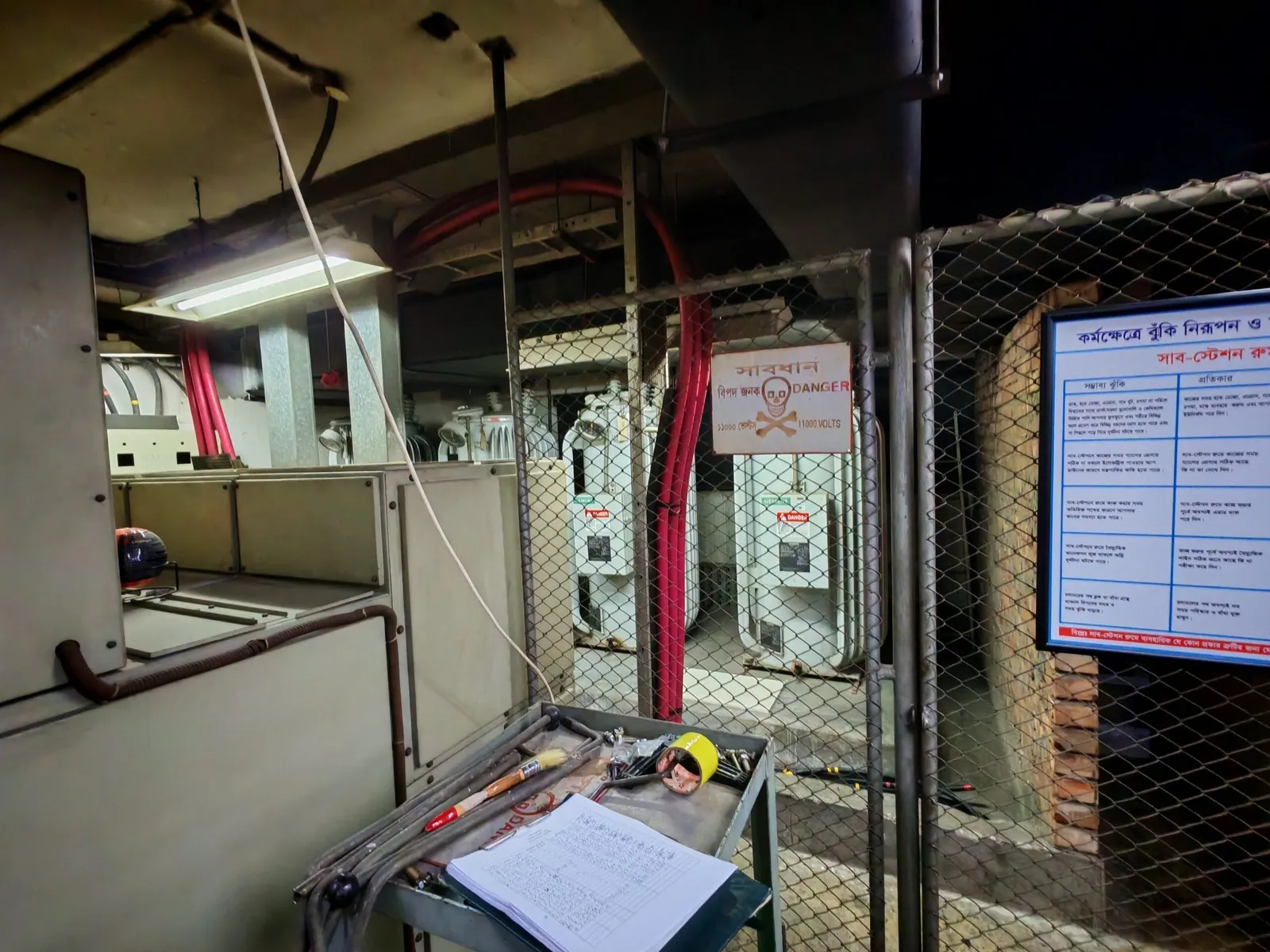 Low-voltage substation room with panels and an inspection notice board