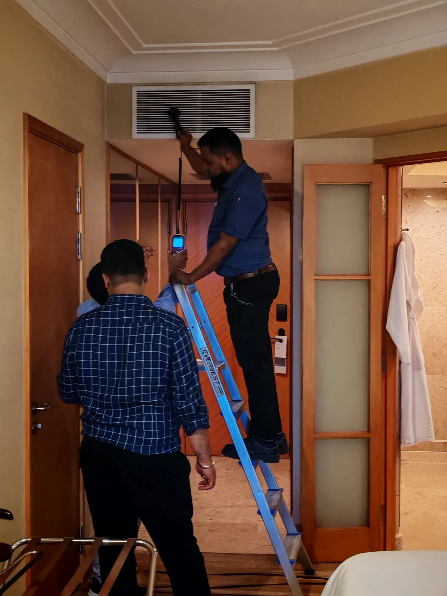 Engineers carrying out a thermal survey in a hotel corridor