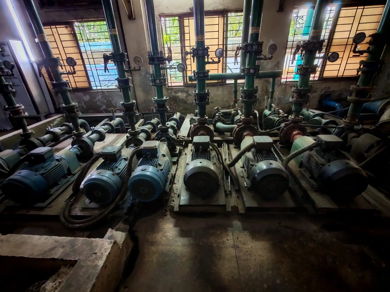 Bank of motor-driven pumps in a factory utility room