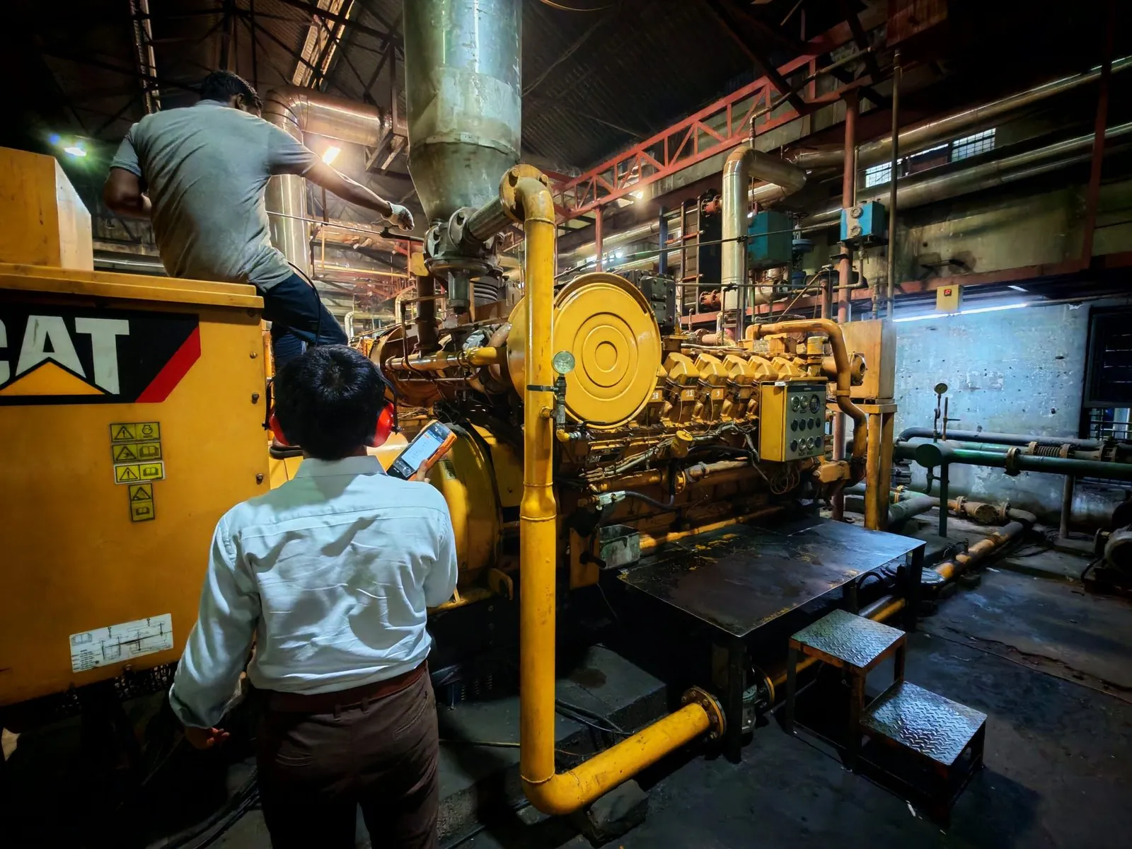 Engineer inspecting a gas generator set