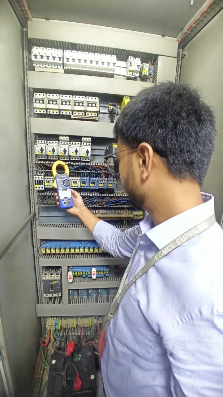 Engineer checking a low-voltage panel with a thermal camera