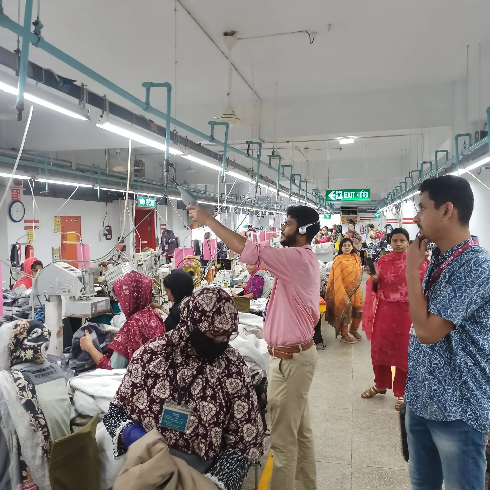 Engineers walking a garment production line