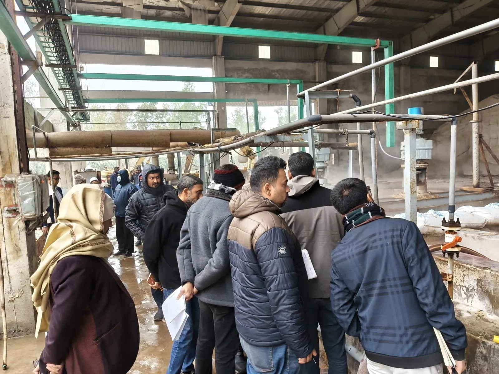 Audit team and plant staff on a walk-through of a factory utility yard